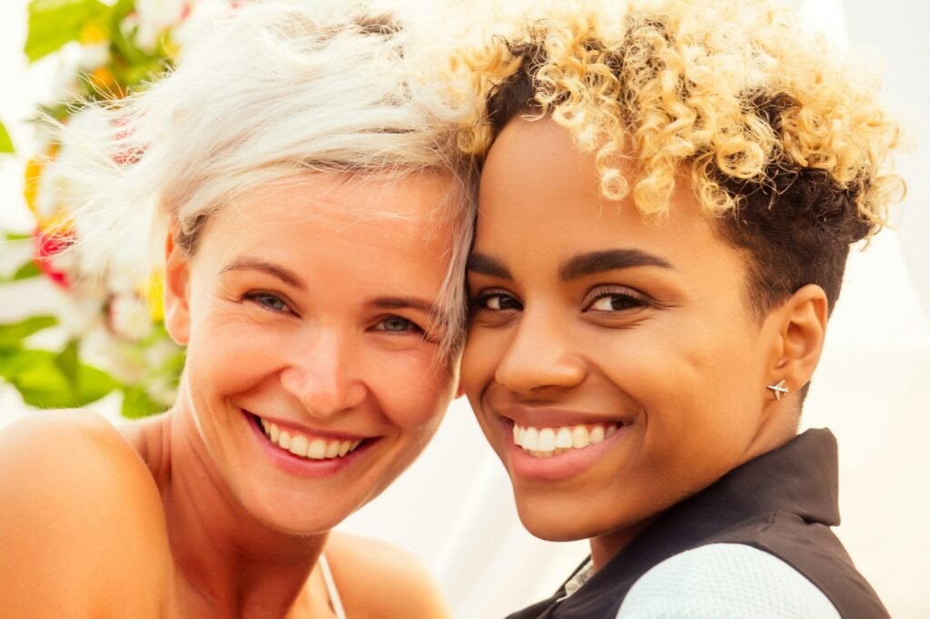 blonde human hair afro american female in the role of the groom and short blonde haired bride in blue dress