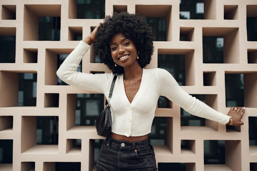 5 Classic Wig Styles That Never Go Out of Fashion Stylish pretty african woman with hairstyle posing near geometric wall